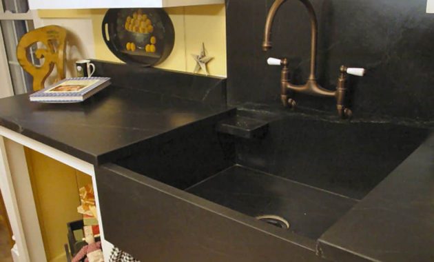 Traditional Kitchen Designed With Black Countertops And Stone Sink with regard to dimensions 1024 X 768